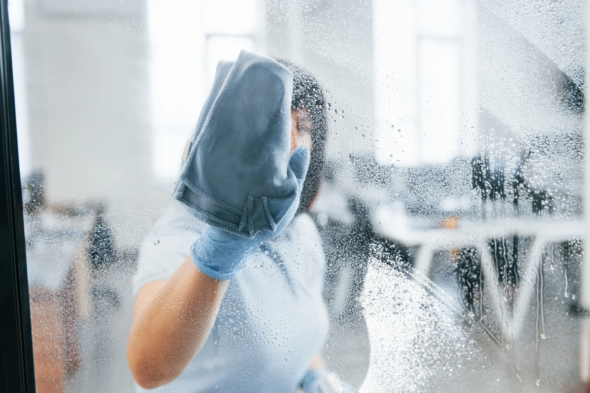 woman-cleaning-dirty-window-by-using-towel-view-t-2026-01-08-23-44-38-utc
