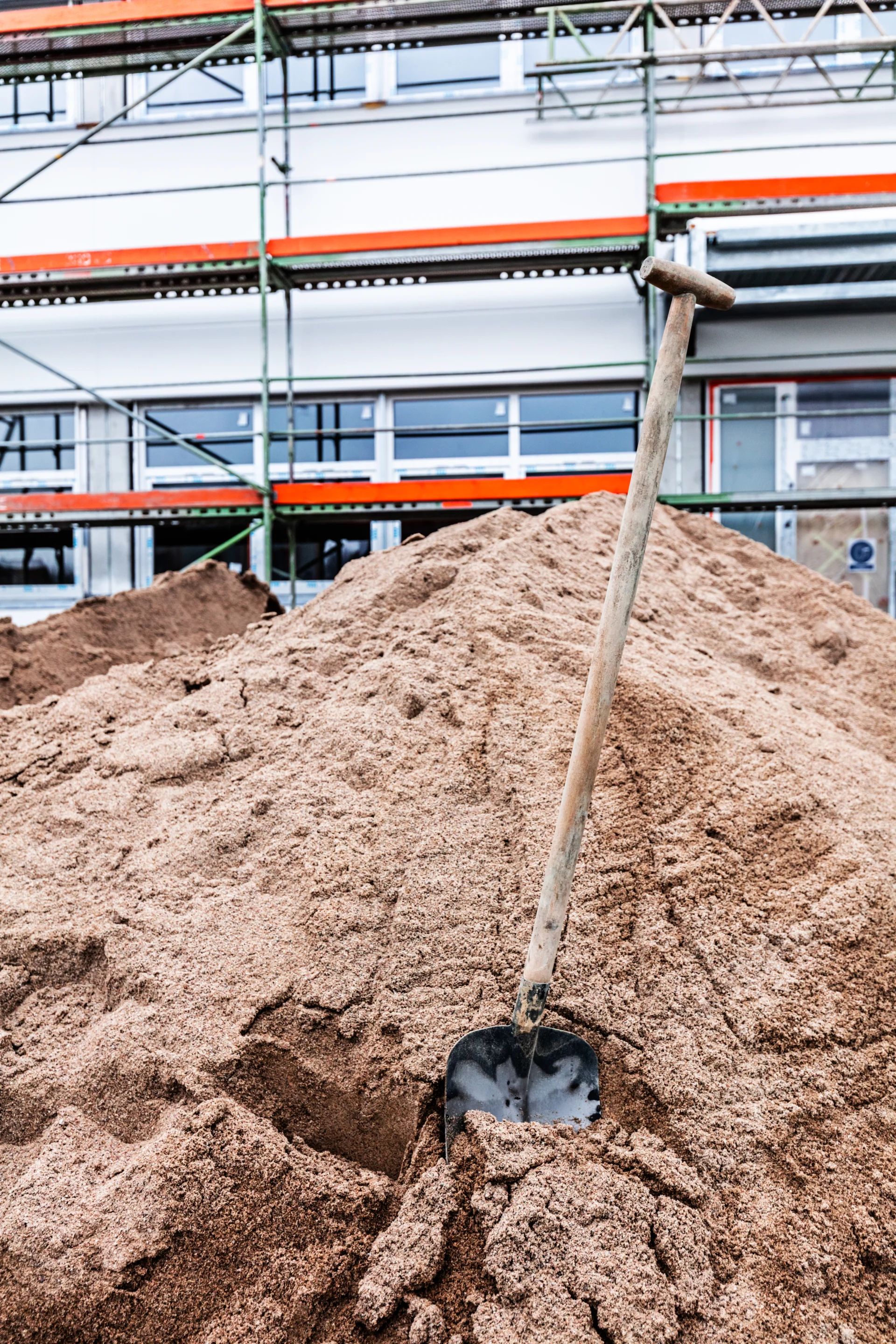 shovel-stuck-in-the-ground-at-new-office-and-wareh-2026-01-09-07-03-14-utc